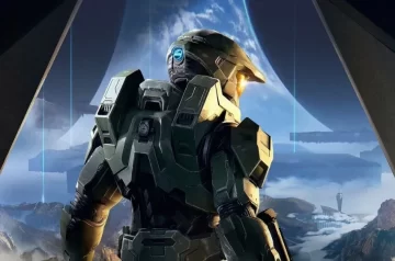 Master Chief w swojej Spartańskiej zbroi stojący tyłem do ekranu. Grafika z gry Halo Infinite, od studia 343 Industries.