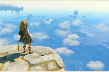 Link stojący na górze i patrzący na panoramę Hyrule skrytą wśród chmur w Tears of the Kingdom