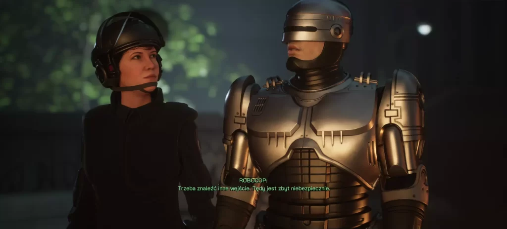 RoboCop oraz jego partnerka rozmawiający na tle miasta