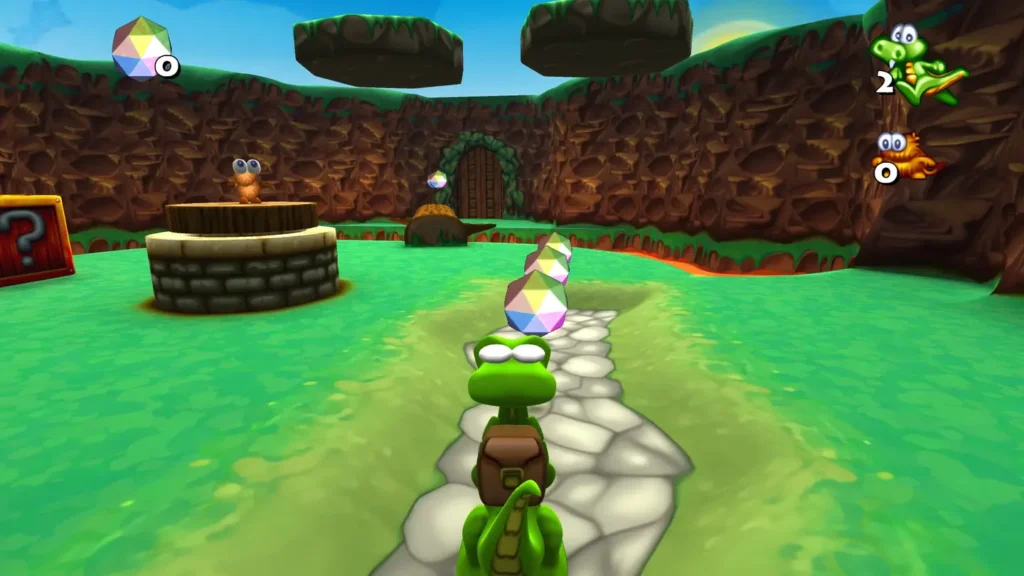 Obraz z gry Croc: Legend of the Gobbos. Jest to jeden z pierwszych poziomów. Na ekranie widać Croca, studnie, diamenty i zielone podłoże przedzielone rzeką lawy.