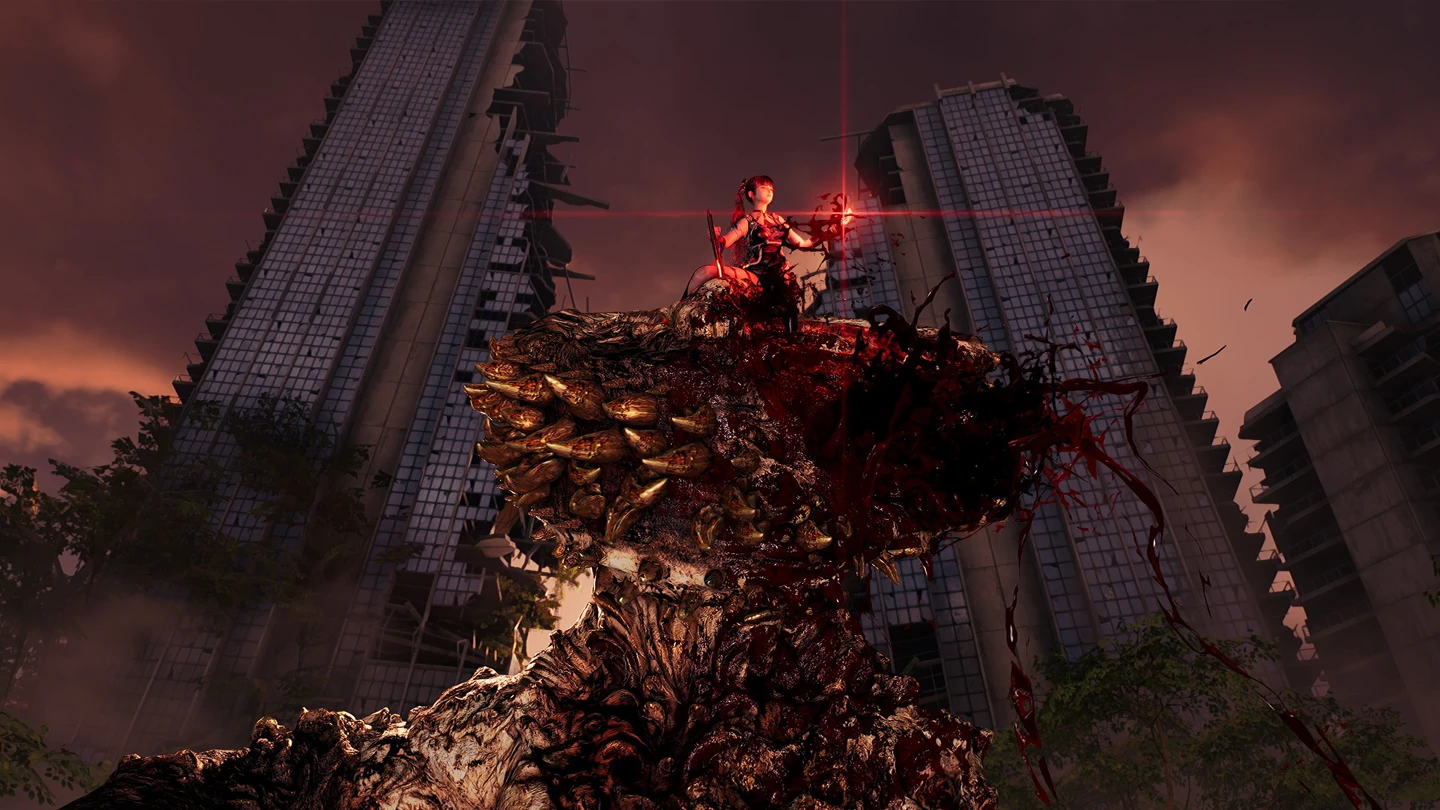 Postać z gry stoi na pokonanym, groteskowym potworze na tle zniszczonych wieżowc&oacute;w.