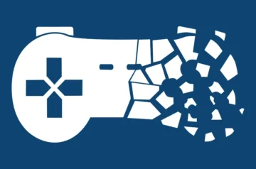Grafika przedstawiająca biały pad do gier pękający i rozpadający się na fragmenty na niebieskim tle, symbol inicjatywy Stop Killing Games.