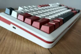 Lewy bok klawiatury Redragon Stormhunter na drewnianym blacie.