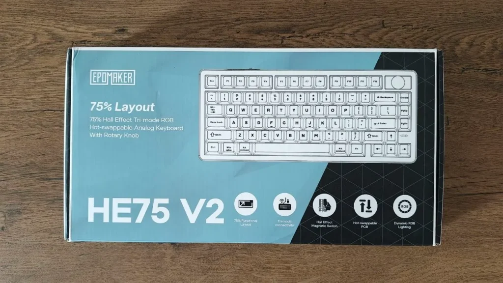 Frontowe opakowanie klawiatury EPOMAKER HE75 V2 ze schematem układu klawiszy oraz ikonami głównych funkcji technicznych.